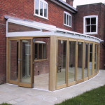 Aluminium conservatory roof covering a hardwood conservatory.